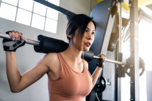 woman lifting weights in gym